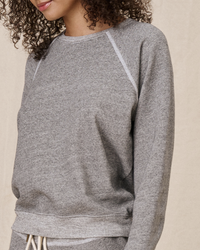 Woman wearing The Shrunken Sweatshirt in Varsity Grey by the Great with white trim detailing.