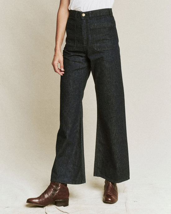 Person wearing high-waisted wide-leg the Great dock jeans paired with brown leather boots.