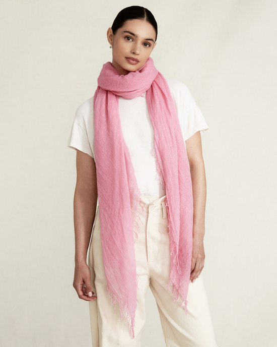 Woman wearing a white t-shirt and cream pants with a Chan Luu Cashmere & Silk Scarf in Sachet Pink.