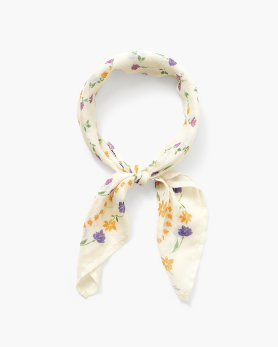 A Chan Luu Spring Floral Bandana in Cream tied in a knot on a white background.