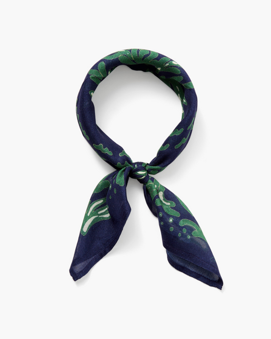 Seaweed Print Bandana in Estate Blue by Chan Luu, tied in a knot, isolated on a white background.
