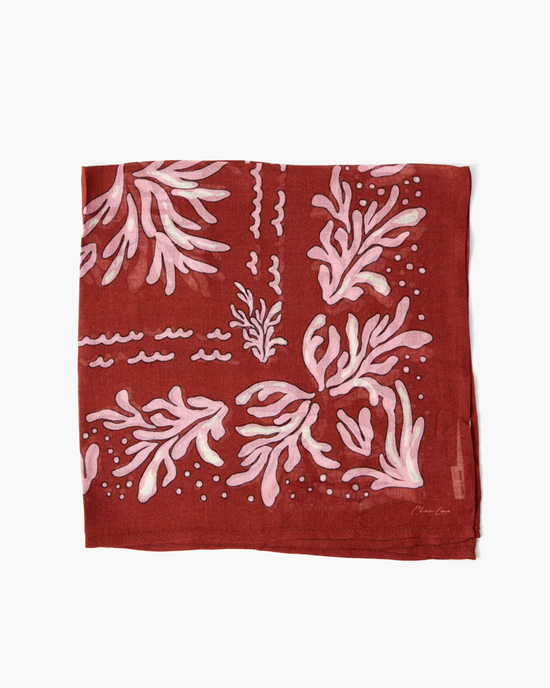 A red and white Seaweed Print Bandana with abstract marine-inspired designs displayed flat on a white background from Chan Luu.