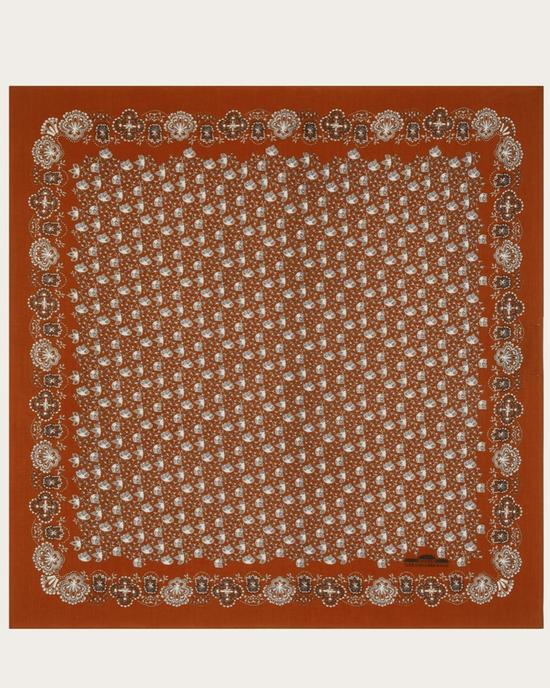 An ornate, brown square Bandana No 675 in Tomette with detailed white circular and Mois Mont floral patterns and a border design.