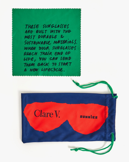 Two colorful fabric pouches for Clare V. Heather Sunglasses in Loden, with text explaining the product's sustainable materials and lifecycle, including recycled and bio-based materials.