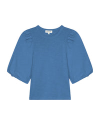 The Nation LTD Tippi Top in Harbor Blue is crafted from soft slub cotton, featuring puff sleeves, a crew neckline, and a slightly loose fit, shown against a white background.