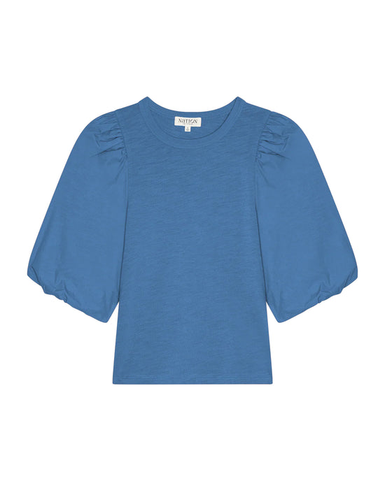 The Nation LTD Tippi Top in Harbor Blue is crafted from soft slub cotton, featuring puff sleeves, a crew neckline, and a slightly loose fit, shown against a white background.