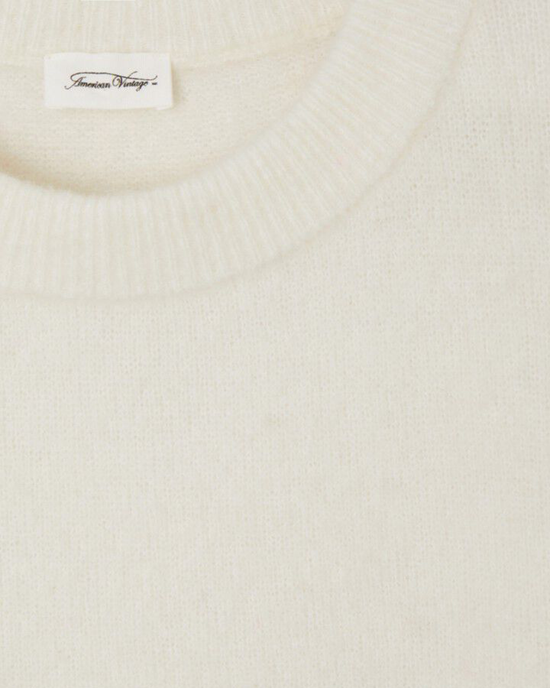 Close-up of a cream-colored crewneck Vito Crop Sweater in Blanc with an "American Vintage" brand label.