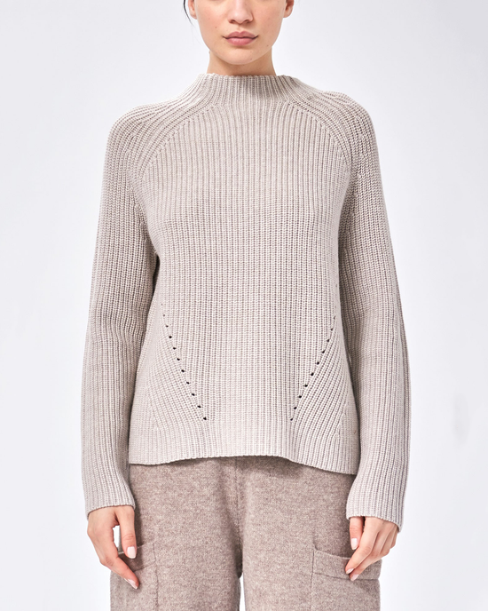 Woman wearing a Demylee Daphne Wool Sweater in Oatmeal with an asymmetric hem.