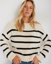 Woman wearing a Not Monday Madison Stripe Pullover in Ivory Stripe with black horizontal stripes.
