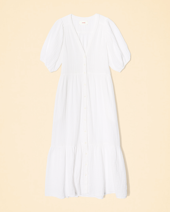 White cotton gauze XiRENA Lennox dress with short sleeves on a beige background.