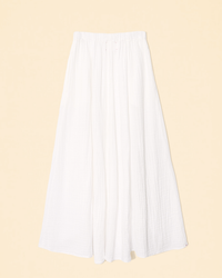 Deon Skirt in White cotton gauze pleated skirt against a pale background by XiRENA.