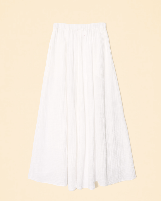 Deon Skirt in White cotton gauze pleated skirt against a pale background by XiRENA.