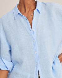 The Brighton Long Sleeve Button Up in Sailboat by Velvet by Graham & Spencer features light blue linen, white buttons, a point collar, and rolled sleeves—your new favorite shirt for effortless style.