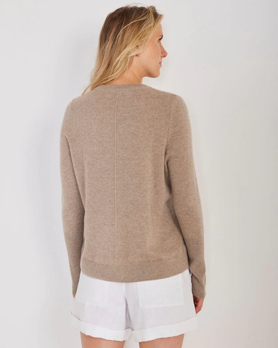Woman wearing a Not Monday Chase Cashmere Crewneck in Latte and white shorts, viewed from the back.