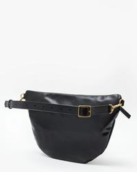 The Clare V. Grande Fanny in Black Nouveau is an Italian leather belt bag with gold hardware, a smooth finish, and a wide adjustable strap, shown on a plain white background.
