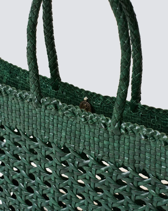 Close-up of a Cannage Kanpur Big in Forest Green handwoven leather tote bag with braided handles from Dragon Diffusion.