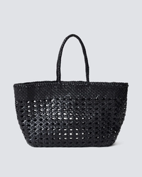 Handwoven leather Cannage Kanpur Big tote bag from Dragon Diffusion against a grey background.