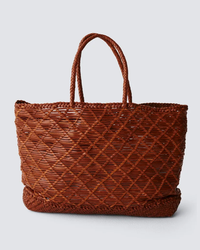 Handmade woven brown leather EW Corso Bag in Tan displayed against a neutral background by Dragon Diffusion.