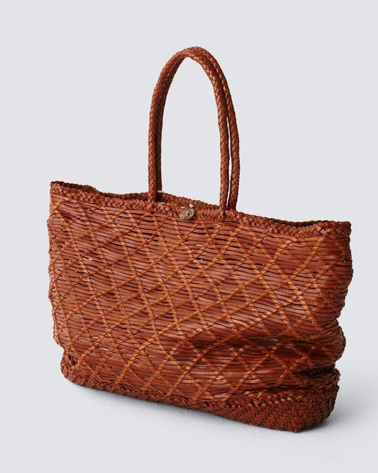Woven tan Dragon Diffusion EW Corso tote bag on a neutral background.