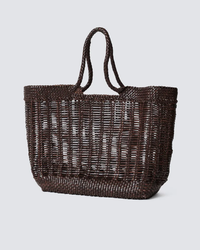 A Dragon Diffusion Window Basket in Dark Brown hand-woven tote bag against a neutral background.