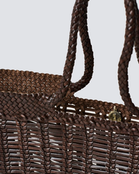 Close-up of a Window Basket in Dark Brown with intricate weaving and a metal clasp by Dragon Diffusion.