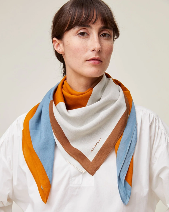 Woman wearing a white blouse and a Mois Mont Bandana No 717 in Tobacco.