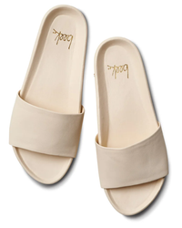 A pair of Gallito in Eggshell leather beek. slides on a white background.