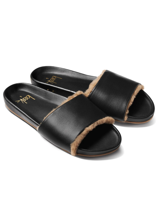 A pair of Gallito Shearling in Black/Bronze slide sandals by beek. on a white background.