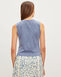A woman seen from behind wearing a Magson Tank Top in Haze by Velvet by Graham & Spencer and a floral skirt.