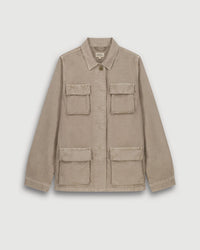 The Vea Jacket in Straw by Hartford is a light beige, military-inspired cotton-linen jacket with a collar, button front, and four large flap pockets, shown against a plain white background.