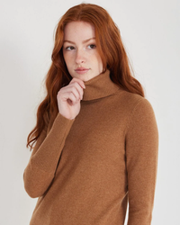 A woman with red hair wearing a brown Not Monday Hayden Cashmere Turtleneck in Toffee sweater.