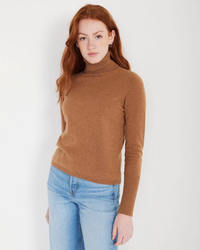 Woman in a brown Not Monday Hayden Cashmere Turtleneck in Toffee sweater and blue jeans.