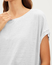 Close-up of a woman wearing a Hudson S/S Crew Neck Top in White by Velvet by Graham & Spencer.