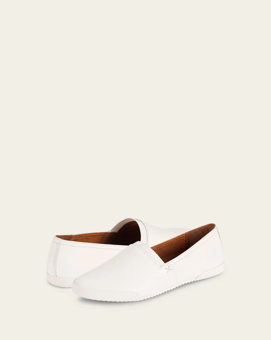 A pair of white FRYE Melanie Slip-On leather sneakers against a plain background.