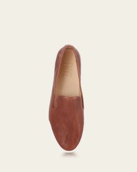 Single FRYE Mia Slip On cognac leather loafer with a removable footbed isolated on a white background.