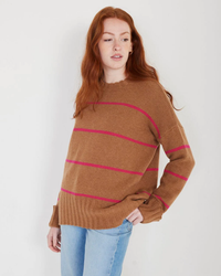 Woman in a Not Monday Mila Cashmere Crewneck Sweater in Toffee & Winter Pink Stripe posing against a white background.