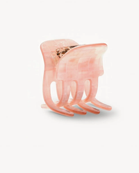 A pink translucent Italian acetate Machete Mini Claw in Apricot Shell Checker hair clip on a white background.