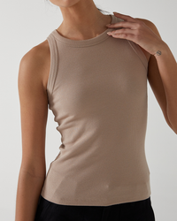 Woman in a Nude ribbed velvet Cruz tank by Velvet by Graham & Spencer, cropped view showing from neck to waist against a light background.