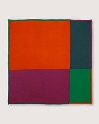 The Bandana No 751 in Poppy Red by Moismont is a square textile made from a blend of wool, silk, and cashmere. It features bold blocks of orange, dark teal, purple, and green in a striking geometric design.