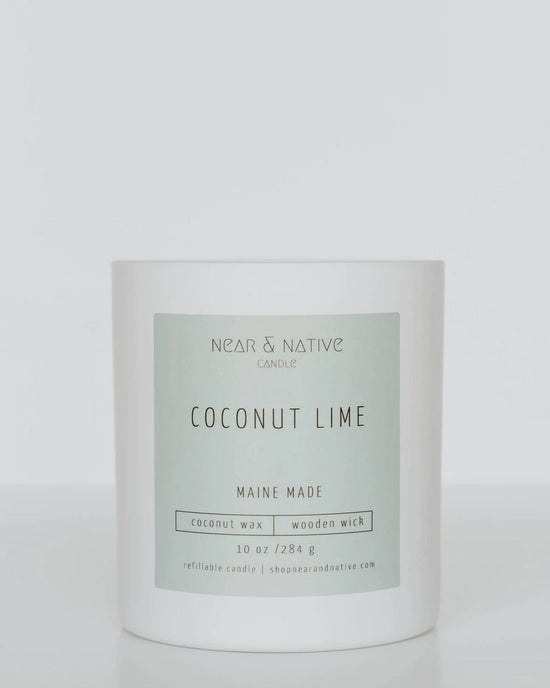 The Near & Native Coconut Lime Candle features a green label, 10 oz of natural coconut soy wax, and a wooden wick. "Maine Made," it's phthalate and paraben-free for purity.