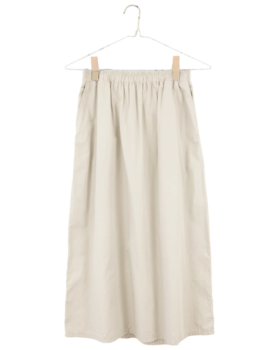 Everyday Skirt in Natural by It is well LA on a hanger against a white background.