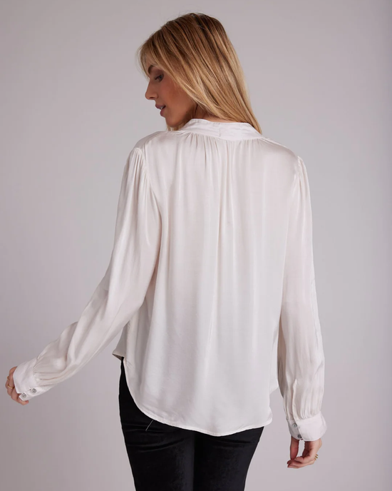 Woman wearing a Bella Dahl Shirred Button Up Blouse in Soft Alabaster from the holiday capsule collection.
