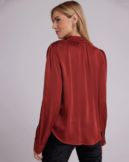 Woman wearing a Bella Dahl Shirred Button Up Blouse in Warm Brandy with a gathered neckline, viewed from the side.