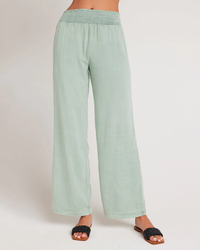 Woman wearing Oasis Green Smocked Waist Wide Leg Pant from Bella Dahl and black sandals.