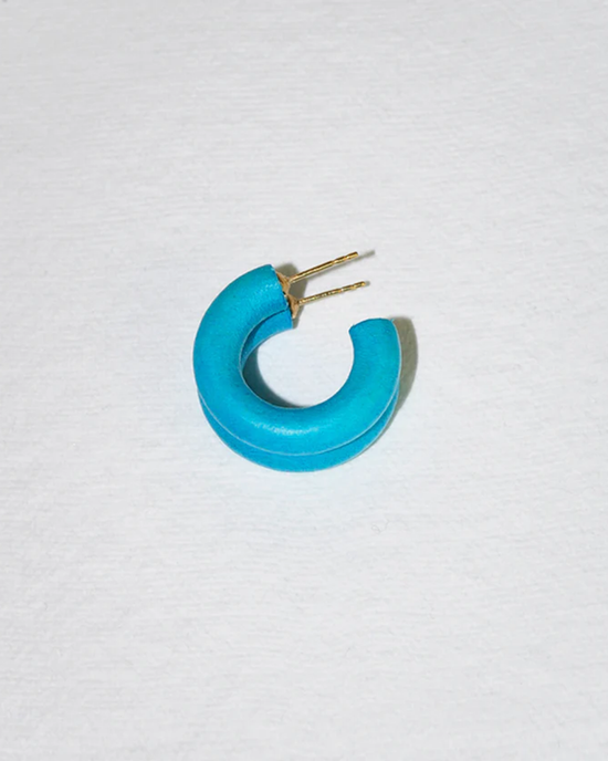 A C Hoop in Mini in Ken from B&L placed on a white surface with sustainably sourced mango wood earrings.
