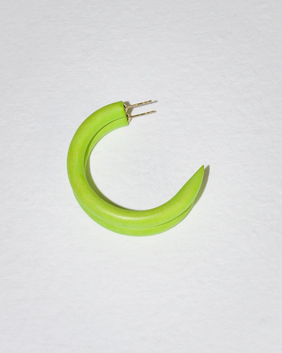 A C Hoop in Small in Lime Rickey creatively manipulated to resemble a green chili pepper against a white background, adorned with sustainably sourced mango wood earrings by B&L.