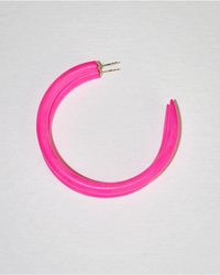 A bright pink hairband laid out on a white surface, accompanied by B&L's C Hoop in Large in Barbie sustainably sourced mango wood earrings.