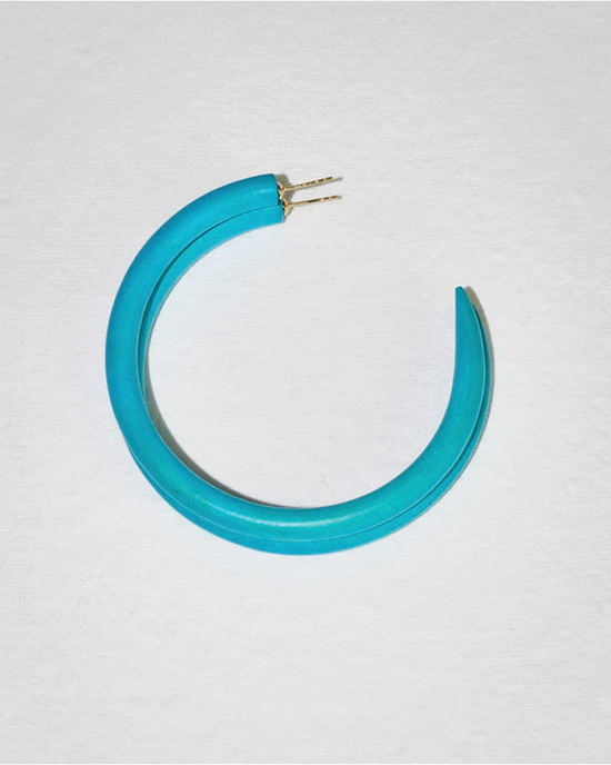 A blue C Hoop in Large belt with a hand-carved gold buckle on a white background by B&L.