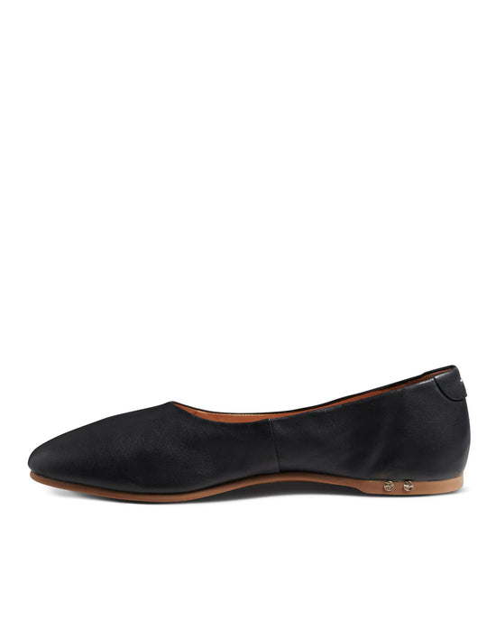 The beek.. Swiftlet in Black is a black leather ballet flat with a pointed toe, tan sole, and small silver heel studs. It features a memory foam cushion sole for comfort and is shown in side profile against a white background.