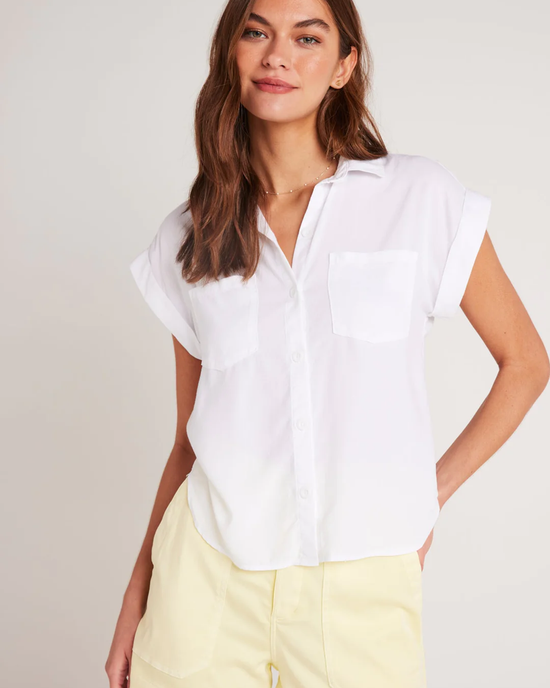 Woman posing in a Bella Dahl Two Pocket S/S Shirt in White and yellow shorts made from Tencel.